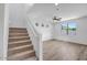 Open living area with tiled staircase, modern flooring, and ample natural light at 5534 W Banff Ln, Glendale, AZ 85306