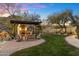 Landscaped backyard with a grassy area and fire pit at 15419 E Stardust Dr, Fountain Hills, AZ 85268