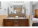 Double vanity bathroom with granite countertops and large mirror at 15419 E Stardust Dr, Fountain Hills, AZ 85268