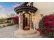 Inviting entryway with stone arch and wrought iron door at 15419 E Stardust Dr, Fountain Hills, AZ 85268