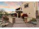 Elegant home entrance with brick pathway and red flowers at dusk at 15419 E Stardust Dr, Fountain Hills, AZ 85268