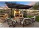 Outdoor fireplace with seating under a pergola at 15419 E Stardust Dr, Fountain Hills, AZ 85268