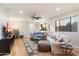 Bright living room with hardwood floors, comfy sofas, and a large TV at 15419 E Stardust Dr, Fountain Hills, AZ 85268