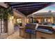 Well-equipped outdoor kitchen under a pergola at 15419 E Stardust Dr, Fountain Hills, AZ 85268