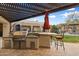 Outdoor kitchen with built-in grill and pergola at 15419 E Stardust Dr, Fountain Hills, AZ 85268