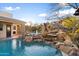 Resort-style pool with waterfall feature and spacious patio at 15419 E Stardust Dr, Fountain Hills, AZ 85268