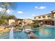 Inviting pool and spa area with waterfall feature and lush landscaping at 15419 E Stardust Dr, Fountain Hills, AZ 85268