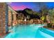 Stunning pool with waterfall feature at dusk, surrounded by desert landscaping at 15419 E Stardust Dr, Fountain Hills, AZ 85268
