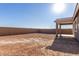 Sunny backyard, featuring a covered patio and a large grassy area at 21615 N Daniel Dr, Maricopa, AZ 85138
