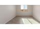 Simple bedroom with tile flooring and a window at 21615 N Daniel Dr, Maricopa, AZ 85138