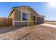 House exterior showcasing a two-car garage and a stone facade at 21615 N Daniel Dr, Maricopa, AZ 85138