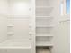 Bright bathroom featuring a tub, shower and white shelving for storage at 22489 W Pontiac Dr, Surprise, AZ 85387