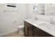 Bathroom featuring dual sinks with modern fixtures, dark wood cabinets and white countertops at 22489 W Pontiac Dr, Surprise, AZ 85387