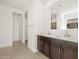 This bathroom features double sinks and dark wood cabinets at 22489 W Pontiac Dr, Surprise, AZ 85387