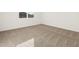 This bedroom features neutral carpet and a large window at 22489 W Pontiac Dr, Surprise, AZ 85387