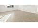 Bright bedroom features a large window and wood-look tile flooring at 22489 W Pontiac Dr, Surprise, AZ 85387