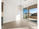 Bright dining area with wood-look tile floors and modern globe chandelier at 22489 W Pontiac Dr, Surprise, AZ 85387