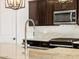 Modern kitchen featuring granite countertops, dark wood cabinets, and stainless steel appliances at 22489 W Pontiac Dr, Surprise, AZ 85387