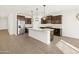 This spacious kitchen offers stainless steel appliances and a large island with pendant lighting at 22489 W Pontiac Dr, Surprise, AZ 85387