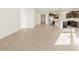 Bright living area with wood-look tile and an open concept to the kitchen at 22489 W Pontiac Dr, Surprise, AZ 85387