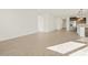 Spacious living area with open floor plan and wood-look tile flooring at 22489 W Pontiac Dr, Surprise, AZ 85387