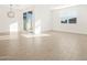 Light-filled living room with wood-look tile and sliding glass door at 22489 W Pontiac Dr, Surprise, AZ 85387