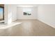 Bright, open living room features wood-look tile and a window at 22489 W Pontiac Dr, Surprise, AZ 85387