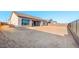 A wide shot of the backyard of a house with desert landscaping and a fenced perimeter at 24691 N 169Th Ave, Surprise, AZ 85387