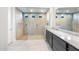 Modern bathroom features a large glass-enclosed shower, dual vanity, and neutral tiling at 24691 N 169Th Ave, Surprise, AZ 85387