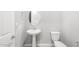Powder room featuring a pedestal sink, toilet, and neutral color scheme at 24691 N 169Th Ave, Surprise, AZ 85387