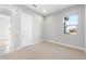 Bright bedroom featuring carpet, a white door and a window with neighborhood view at 24691 N 169Th Ave, Surprise, AZ 85387
