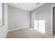 An interior view of a bedroom with carpet flooring, window and a door to the next room at 24691 N 169Th Ave, Surprise, AZ 85387