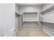 Walk-in closet featuring ample storage space, shelving, and neutral carpeting at 24691 N 169Th Ave, Surprise, AZ 85387