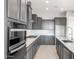 Close-up view of kitchen appliances, stylish gray cabinets, and bright countertops at 24691 N 169Th Ave, Surprise, AZ 85387