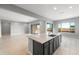 Bright, open-concept kitchen features a central island, modern appliances, and flows into the living area at 24691 N 169Th Ave, Surprise, AZ 85387