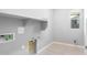 Bright laundry room with tile floors, utility sink, and built-in shelving for easy storage solutions at 24691 N 169Th Ave, Surprise, AZ 85387