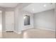 Bright, open-concept living room featuring neutral paint and tile floors; a bright and airy space at 24691 N 169Th Ave, Surprise, AZ 85387