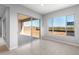 This living room features neutral paint colors, sleek flooring, a sliding glass door, and expansive window at 24691 N 169Th Ave, Surprise, AZ 85387