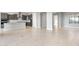 Open-concept living space connecting to kitchen; light tile flooring, neutral walls, and abundant natural light at 24691 N 169Th Ave, Surprise, AZ 85387