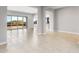 Open floor plan with large sliding glass doors leading to the backyard and view into the kitchen at 24691 N 169Th Ave, Surprise, AZ 85387