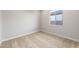 Carpeted bedroom with a window overlooking the backyard, offering a cozy and private space at 24707 N 169Th Ave, Surprise, AZ 85387