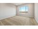 Carpeted bedroom featuring a large window with views of the landscape and plenty of natural light at 24707 N 169Th Ave, Surprise, AZ 85387