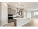 Modern kitchen features stainless steel appliances, subway tile backsplash, white quartz counters, and a large island at 24707 N 169Th Ave, Surprise, AZ 85387