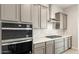 Close-up of kitchen featuring gray cabinets, stainless steel appliances, and white subway tile backsplash at 24707 N 169Th Ave, Surprise, AZ 85387