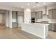 Modern kitchen boasts gray cabinets, stainless steel appliances, and a spacious center island at 24707 N 169Th Ave, Surprise, AZ 85387
