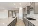 Modern kitchen with gray cabinetry, stainless steel appliances, a large island, and an open layout at 24707 N 169Th Ave, Surprise, AZ 85387