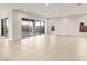 Bright living room featuring tiled floors and large sliding glass doors leading to the patio at 24707 N 169Th Ave, Surprise, AZ 85387