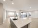 Open floor plan with a large kitchen island flowing into a living area with expansive windows at 24707 N 169Th Ave, Surprise, AZ 85387
