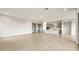 Open-concept living space features tile flooring and a modern kitchen with a large island and stainless steel appliances at 24707 N 169Th Ave, Surprise, AZ 85387