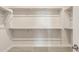 Walk-in closet with built-in shelving providing ample storage space in the primary suite at 24707 N 169Th Ave, Surprise, AZ 85387